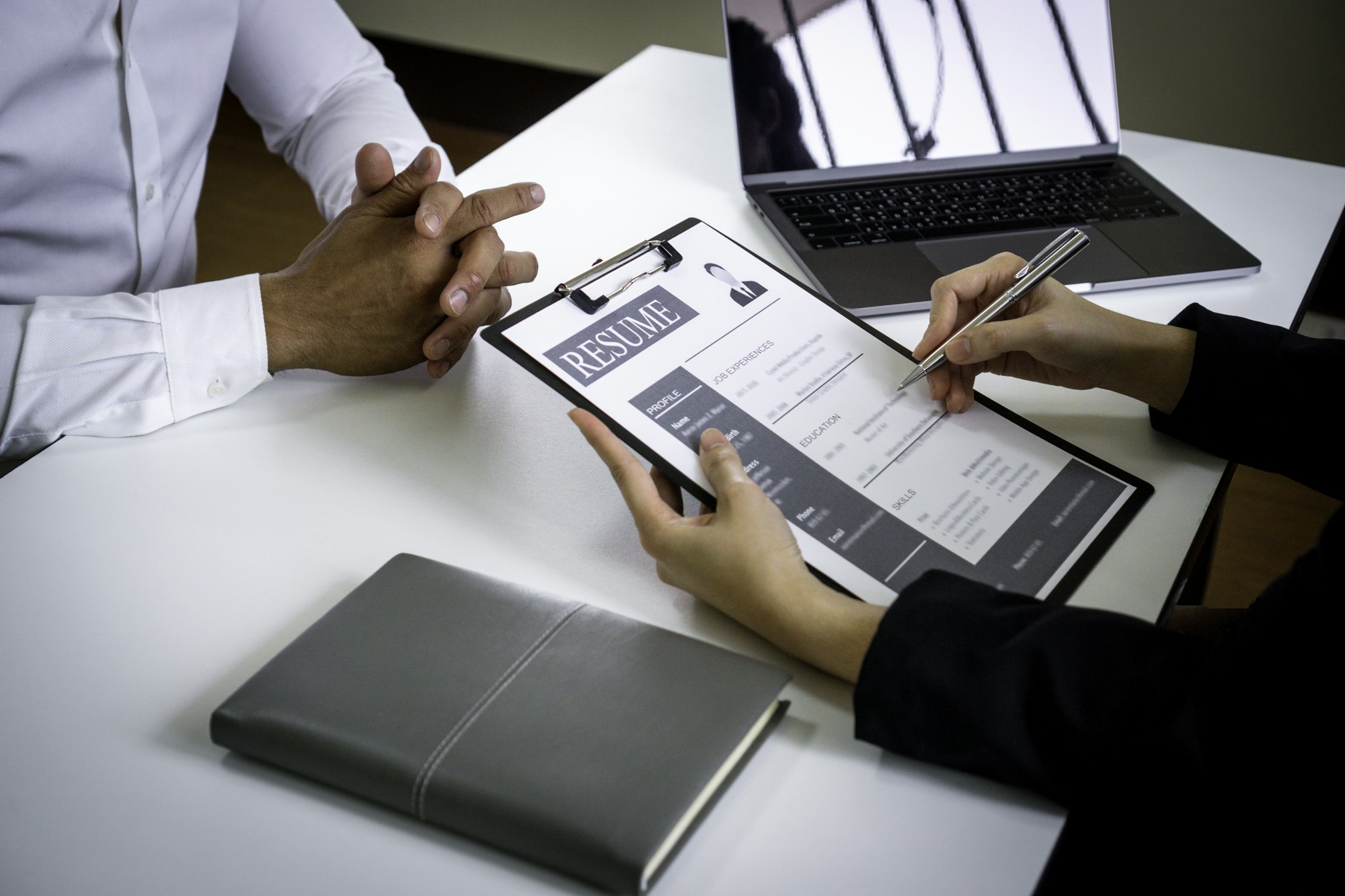 close up view of finance company interviews The head of the HR department focuses on writing a speci